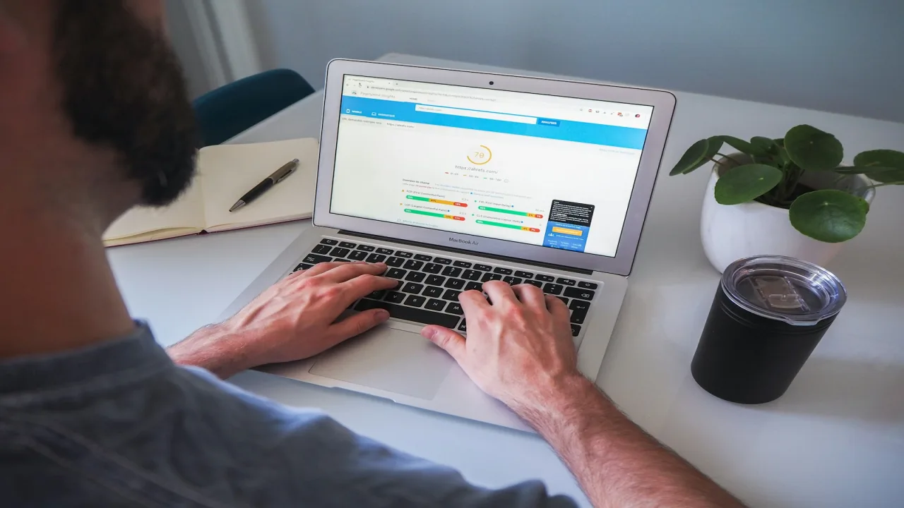 SEO specialist reviewing PageSpeed and technical performance metrics on a laptop